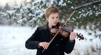 Young male violinist performing outdoors in winter snow scene with evergreen trees. Classical music student practicing instrument in cold weather landscape.
