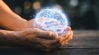 Hands gently holding glowing digital brain hologram with neural networks, representing artificial intelligence, mental health, innovation and futuristic technology.
