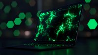 Modern laptop displaying glowing green digital world map with hexagonal bokeh background, concept of global technology and cybersecurity in dark environment.
