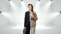 Professional businesswoman in split formal attire holding briefcase against white studio background with dramatic lighting for corporate presentations.