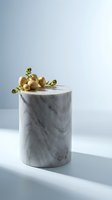 Elegant marble cylinder pedestal with dried flowers and berries on clean white surface for luxury product display and modern interior design.