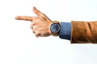 Male hand with luxury watch and business suit sleeve pointing finger to side on white background, isolated professional gesture for presentations.