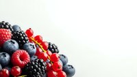 Fresh mixed berries including blueberries, raspberries and blackberries on white background for healthy eating and nutrition concepts.
