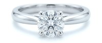 Classic solitaire diamond engagement ring with brilliant cut stone on white gold band isolated on white background for jewelry design and wedding concepts.
