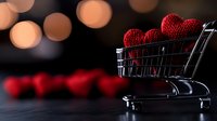 Red knitted heart decorations in mini shopping cart against dark background with bokeh lights, romantic Valentine's day concept for retail and love.
