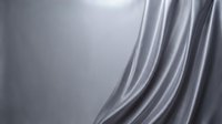 Smooth silver metallic surface with flowing curved lines and reflective highlights creating elegant abstract background for luxury design projects.