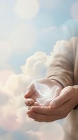 Hands holding glowing white light against cloudy sky background, symbolizing hope, spirituality, and healing for wellness, faith, and inspirational concepts.