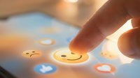 Finger touching glowing smiley face emoji on digital screen surrounded by social media icons, representing positive feedback, customer satisfaction, and online engagement for web and app design.