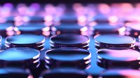 Metallic round discs in rows with vibrant blue and pink neon lighting creating futuristic technological mood. Abstract background with selective focus and bokeh effect.