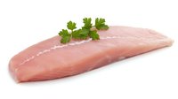 Fresh raw turkey breast fillet garnished with parsley leaves on white background, isolated. Clean protein food photography for culinary and menu design.