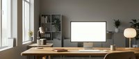 Modern minimalist home office workspace with blank computer monitor on wooden desk ready for mockup and branding. Clean Scandinavian interior design setup.