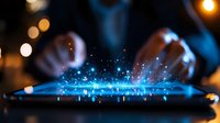 Digital tablet screen emitting magical blue light particles and sparkles while hands interact with device in dark environment, creating futuristic technology concept.
