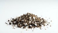Organic chia seeds pile isolated on white background. Healthy superfood ingredient for smoothies, breakfast bowls and nutritious recipes.