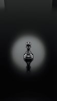 Single chess pawn piece standing alone in dramatic spotlight on dark reflective surface symbolizing leadership potential and strategic thinking.