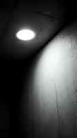 Modern recessed ceiling light fixture illuminating concrete interior space with dramatic shadows and architectural details, suitable for commercial, industrial, and contemporary design projects.