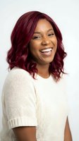 Happy African American woman with burgundy hair laughing in cream sweater on white background for lifestyle and portrait photography projects.