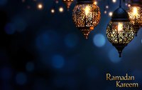 Traditional ornate Arabic lanterns glowing against dark blue bokeh background with golden Ramadan Kareem text, creating magical festive atmosphere.