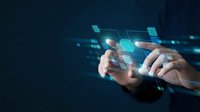 Hands interacting with futuristic holographic interface displaying glowing digital elements and data visualization on dark blue background for technology concepts.