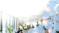 Blurred office environment with business professionals working, overlaid with glowing digital icons representing law, finance, and data analytics for corporate solutions.