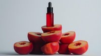 Red serum bottle with dropper surrounded by fresh peach halves on white background for skincare and cosmetic product marketing.