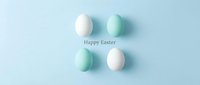 Pastel Easter eggs in white and mint green arranged on a soft blue background with Happy Easter text, minimalist holiday greeting card.