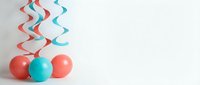 Colorful party balloons with spiral streamers on white background for birthday celebration decoration and festive event design.