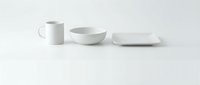 White ceramic dinnerware set with mug, bowl and plate on clean background for kitchen and dining room decor, tableware collection for modern home.