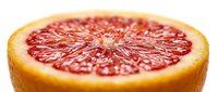 Fresh sliced grapefruit half with vibrant red juicy flesh, close-up macro shot on white background for food and healthy lifestyle concepts.