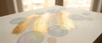 Watercolor bubbles and gold brush stroke on white textured paper, creative art background for design, greeting cards, and invitations.