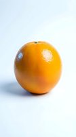 Fresh whole orange with glossy skin and natural highlights isolated on white background, suitable for food, nutrition, and healthy lifestyle content.
