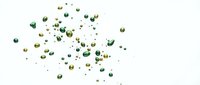 Scattered green and gold confetti pieces floating on white background for party celebrations and festive decorations.
