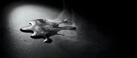Young woman lying unconscious on dark floor in dramatic spotlight, crime scene investigation concept for thriller and mystery storytelling projects.