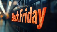 Black Friday sale banner with glowing orange text in modern shopping mall corridor for retail marketing campaigns and promotional advertising materials.