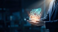 Businessman holding glowing atom symbol in palm representing science, innovation and nuclear energy technology in modern digital environment.