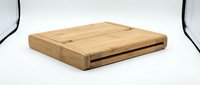 Wooden cutting board with storage drawer and rounded edges, crafted from natural wood for kitchen food preparation and serving needs.
