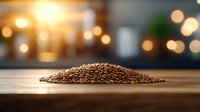 Fresh roasted coffee beans piled on wooden surface with warm bokeh lights in background, creating cozy atmosphere for cafe and coffee shop marketing materials.