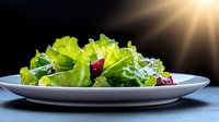Fresh green lettuce salad with red beetroot on white plate against dark background with dramatic sunlight ray, healthy eating concept.