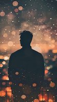 Silhouette of male figure against magical bokeh lights and sparkles in warm orange twilight sky, creating dreamy atmospheric mood for social media and blogs.