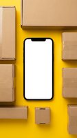 Smartphone with blank white screen surrounded by cardboard delivery boxes on bright yellow background for online shopping and shipping mockup.