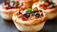 Savory puff pastry tartlets filled with caramelized onions, bacon and fresh herbs make elegant appetizers for entertaining and special occasions.