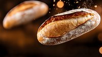 Fresh artisan bread loaves floating in air with golden bokeh lights on dark background for bakery and food design concepts.