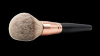 Fluffy powder makeup brush with rose gold ferrule and black handle, isolated on transparent background, ready for beauty clipart, stickers, and print on demand designs.