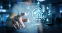 Young Caucasian man touching glowing smart home interface with house icon and connected user network on futuristic digital screen.