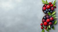 Fresh cranberries and blueberries with green leaves in ceramic bowls on gray background berries for healthy eating.