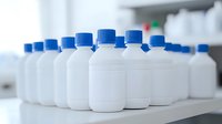White plastic bottles with blue caps arranged in row on laboratory shelf, selective focus on front containers showing medical or chemical storage concept.