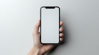 Hand holding modern smartphone with blank white screen against light gray background, mockup for app and website presentation.