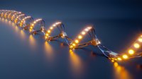 Glowing LED string lights creating curved pattern against dark background, warm yellow illumination with soft reflection for festive decoration.