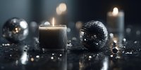 Elegant composition with burning candle and disco balls on dark reflective surface creating atmospheric party mood.