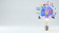 Creative lightbulb with colorful business icons and gears emerging from top, representing innovation, brainstorming and entrepreneurial ideas on white background.