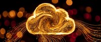 Golden cloud computing symbol with flowing light trails and bokeh background representing digital transformation and data storage technology.